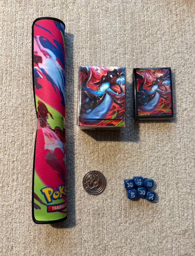 Mega Charizard X ex UPC Contents - 1 Playmat, 1 Deckbox, 1 Coin, 6 Dice, Sleeves Set
